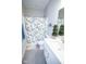 Well-lit bathroom features a decorative shower curtain and a white vanity with sink at 5081 Holborn Ave, McCordsville, IN 46055