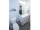 This cozy bathroom features a toilet, vanity with sink, framed mirror, and updated finishes at 5081 Holborn Ave, McCordsville, IN 46055