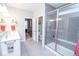 Bathroom featuring a glass-enclosed shower, double sink vanity, and views into the bedroom at 5081 Holborn Ave, McCordsville, IN 46055