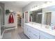 An elegant bathroom featuring double vanity, walk-in closet, and a glass door shower at 5081 Holborn Ave, McCordsville, IN 46055