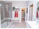 Modern bathroom showcasing walk-in shower with glass door, bench, and towel racks at 5081 Holborn Ave, McCordsville, IN 46055