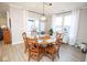 Dining room with round table, six chairs, modern light fixture and lots of light from the window at 5081 Holborn Ave, McCordsville, IN 46055