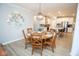View of kitchen and dining room, with wooden dining table and chairs at 5081 Holborn Ave, McCordsville, IN 46055