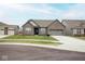 Charming brick home featuring an attached two-car garage, green lawn, and well-kept landscaping at 5081 Holborn Ave, McCordsville, IN 46055