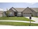 Beautiful single-story brick home with a lush green lawn, and a welcoming front entrance at 5081 Holborn Ave, McCordsville, IN 46055