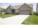 Inviting single-story brick home with attached garage and long driveway at 5081 Holborn Ave, McCordsville, IN 46055