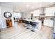 This kitchen has white cabinets, stainless steel appliances, an island with decorative tile, and barstool seating at 5081 Holborn Ave, McCordsville, IN 46055