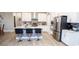 Bright kitchen featuring white cabinetry, stainless steel appliances, and a center island with bar seating at 5081 Holborn Ave, McCordsville, IN 46055
