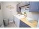 Well-lit laundry room features modern washer/dryer, grey cabinets, butcher block countertop and stylish decor at 5081 Holborn Ave, McCordsville, IN 46055