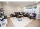 Spacious living room featuring modern decor, ample seating, and large windows at 5081 Holborn Ave, McCordsville, IN 46055