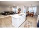 Open-concept kitchen, living room, and dining area featuring a large island and hardwood floors at 5081 Holborn Ave, McCordsville, IN 46055