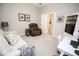 Inviting living room featuring comfortable seating, a desk, and neutral color scheme at 5081 Holborn Ave, McCordsville, IN 46055