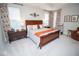 Large bedroom with wood furniture, neutral walls and carpet, and decorative curtains at 5081 Holborn Ave, McCordsville, IN 46055