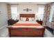 A comfortable and stylish main bedroom featuring a wooden bed frame and patterned curtains at 5081 Holborn Ave, McCordsville, IN 46055