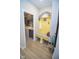 The yellow mudroom includes a bench, storage rack, and ceramic flooring at 5081 Holborn Ave, McCordsville, IN 46055