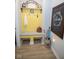 The yellow mudroom includes a bench, storage rack, and ceramic flooring at 5081 Holborn Ave, McCordsville, IN 46055