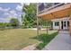 Spacious backyard features a patio with furniture, green grass, and a storage shed at 5226 W Southport Rd, Indianapolis, IN 46221