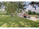Exterior view of home showcasing expansive backyard, patio and furniture at 5226 W Southport Rd, Indianapolis, IN 46221