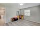 Bright bedroom with tile floors, a bathroom, and natural light from the window at 5226 W Southport Rd, Indianapolis, IN 46221