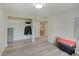 Neutral bedroom with a closet, storage containers, and wood-look flooring at 5226 W Southport Rd, Indianapolis, IN 46221