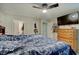 This bedroom features a ceiling fan, carpet, and a flat-screen TV at 5226 W Southport Rd, Indianapolis, IN 46221