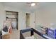 Neutral bedroom featuring closet, gray carpet, and a crib at 5226 W Southport Rd, Indianapolis, IN 46221