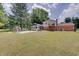 Well maintained home exterior with a large backyard, furniture, patio and green grass at 5226 W Southport Rd, Indianapolis, IN 46221