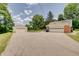 Home with a detached garage and ample parking space on the paved driveway at 5226 W Southport Rd, Indianapolis, IN 46221