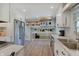 Bright kitchen featuring white cabinets, stainless steel appliances, and modern fixtures at 5226 W Southport Rd, Indianapolis, IN 46221