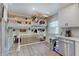 Open kitchen featuring an island pot rack, stainless steel appliances, and natural light at 5226 W Southport Rd, Indianapolis, IN 46221