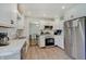 Bright kitchen featuring white cabinets, stainless steel appliances, and modern countertops at 5226 W Southport Rd, Indianapolis, IN 46221