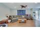 Inviting living room featuring hardwood floors, a comfortable sofa, and ample natural light at 5226 W Southport Rd, Indianapolis, IN 46221