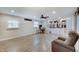 Comfortable living room with wood-style flooring, natural light, and a partial view of the kitchen at 5226 W Southport Rd, Indianapolis, IN 46221