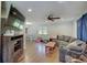 Bright living room with hardwood floors, a ceiling fan, and a comfortable gray sofa at 5226 W Southport Rd, Indianapolis, IN 46221