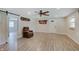 Cozy living room featuring a ceiling fan, natural light, and modern wood-style flooring at 5226 W Southport Rd, Indianapolis, IN 46221