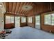 Enclosed sunroom featuring paneled walls, many windows, and a ceiling fan at 5226 W Southport Rd, Indianapolis, IN 46221