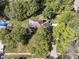 Aerial view of a house surrounded by beautiful, mature trees and green lawns at 5826 Winding Way Ln, Indianapolis, IN 46220
