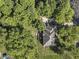 Aerial shot of a home nestled among lush trees with a backyard deck and patio at 5826 Winding Way Ln, Indianapolis, IN 46220