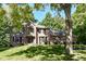 Beautiful brick home with a well manicured lawn and mature trees at 5826 Winding Way Ln, Indianapolis, IN 46220