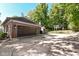 Detached two car garage with dark wood doors and brick siding at 5826 Winding Way Ln, Indianapolis, IN 46220