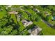 An aerial view showcases well-manicured lawns and mature trees surrounding the property at 5850 E 54Th Pl, Indianapolis, IN 46226