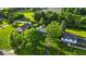 An aerial view showcases well-manicured lawns and mature trees surrounding the property at 5850 E 54Th Pl, Indianapolis, IN 46226