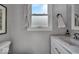 Elegant bathroom featuring a marble countertop, modern fixtures, and a bright, airy ambiance at 5850 E 54Th Pl, Indianapolis, IN 46226