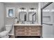 Modern bathroom with double vanity, stylish mirrors, and a glass-enclosed shower at 5850 E 54Th Pl, Indianapolis, IN 46226