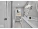 Bright bathroom featuring double sinks, a window, and a shower-tub combination at 5850 E 54Th Pl, Indianapolis, IN 46226