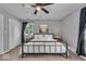 Relaxing bedroom featuring a metal bed, large windows, and a ceiling fan at 5850 E 54Th Pl, Indianapolis, IN 46226