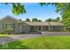 Charming ranch style home with brick and gray accents and a well-manicured lawn at 5850 E 54Th Pl, Indianapolis, IN 46226