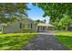 Charming gray brick home with a covered front porch and well-kept lawn at 5850 E 54Th Pl, Indianapolis, IN 46226