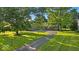 Wide shot of a ranch home with mature trees and a long driveway at 5850 E 54Th Pl, Indianapolis, IN 46226
