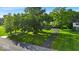 A beautifully landscaped front yard with mature trees provides shade and curb appeal at 5850 E 54Th Pl, Indianapolis, IN 46226